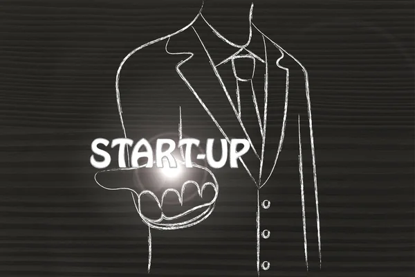 Business man holding the word Start-up