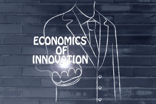 Business man holding the word Economics of Innovation