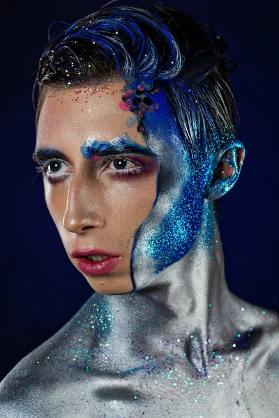 Crazy young androgyne man with face art. SPACEMAN. Freak person.