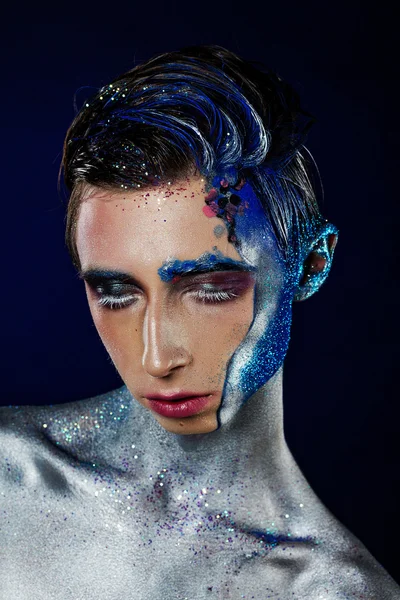 Crazy young androgyne man with face art and closed eyes. SPACEMA