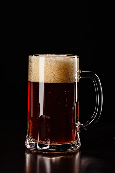 Beer Glass with DROPS on black. FRESH! MUCH FOAM! Beer bubbles c