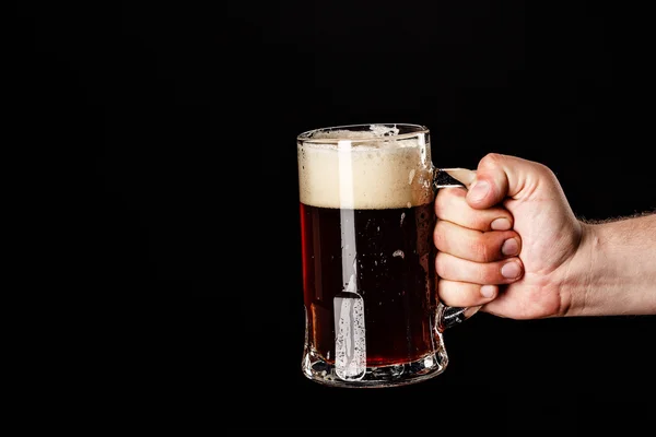 MAN HAND with Beer Glass with DROPS on black. FRESH! MUCH FOAM!