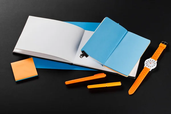 Student girl workplace. open notepads with blue and white pages.
