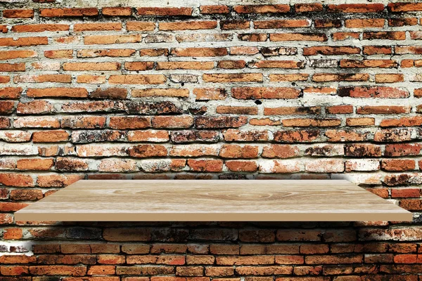 Empty wood shelf on old brick wall background