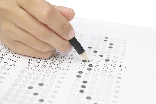 Standardized test form with answers bubbled in and a pencil, foc