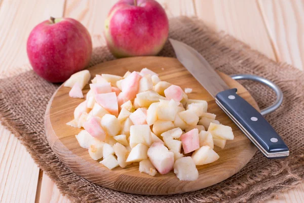 Cut apples on wooden cutting board