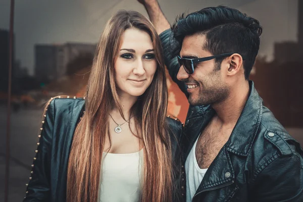 Young trendy man and woman models smiling feeling happy. Fashion Style.