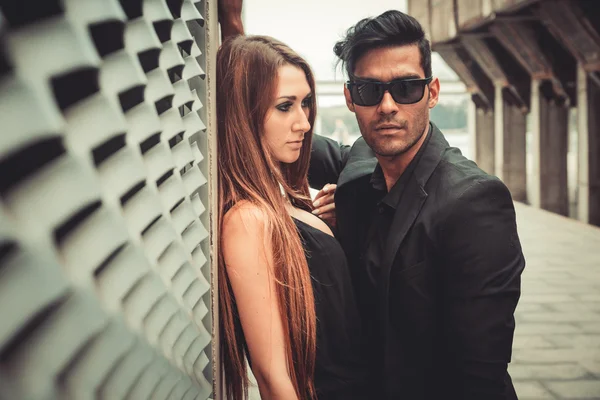 Young trendy man and woman models pose of the modern street. Fashion Style.