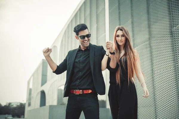 Young trendy man and woman models smiling feeling happy. Fashion Style.