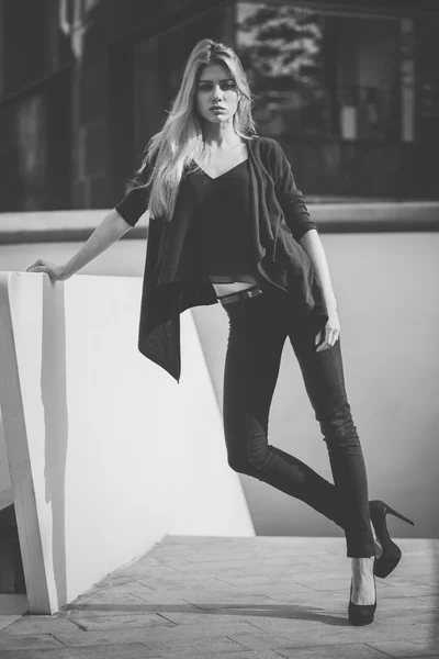 Beautiful young model woman posing in modern architecture environment.