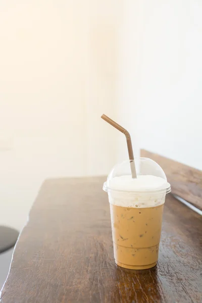 Iced coffee on wooden table in coffee shop in vertical