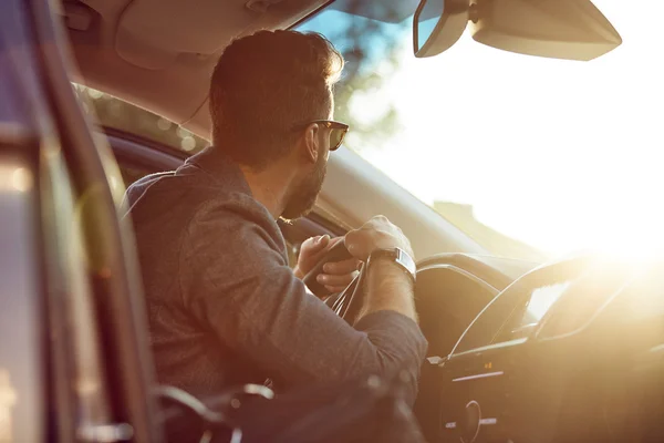 Attractive elegant man in good car