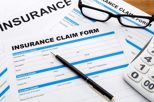 Insurance claim form with pen