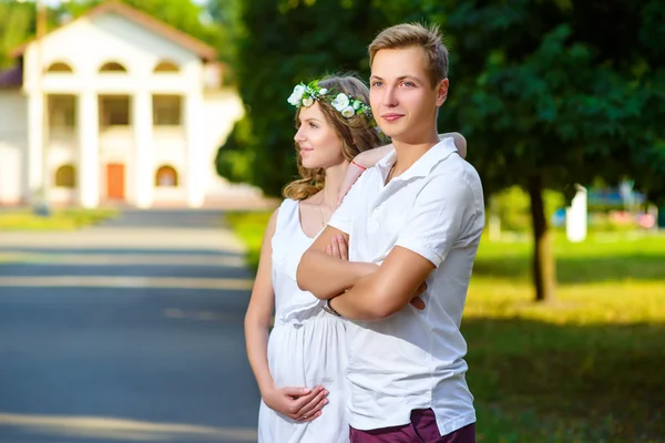 Portrait of beautiful loving couple awaiting baby. Husband and wife maternity expecting a child