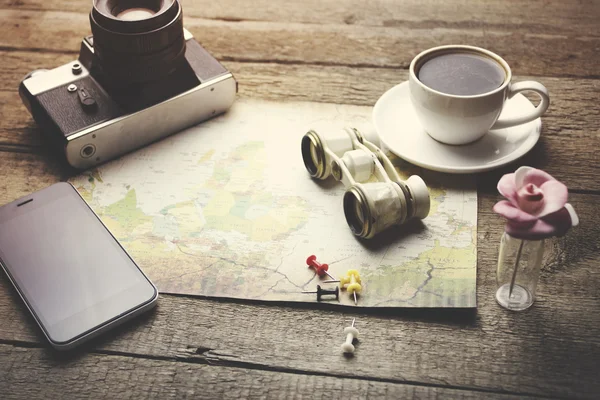 Travel items -binocular, map, coffee, camera and phone
