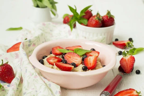 Porridge with berries - strawberries and blueberries