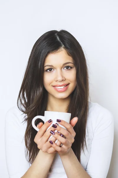 Young pretty woman drinking coffee or tea . Relaxing girl . Woman drinking coffee in the morning at home lifestyle.