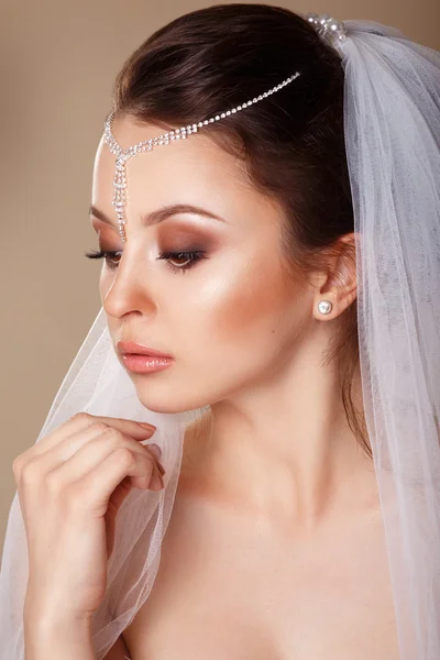 Beautiful young girl with a diadem in her hair. Youth and Skin Care Concept. Wedding. Young Gentle Quiet Bride in Classic White Veil. Portrait of beautiful bride. portrait in profile