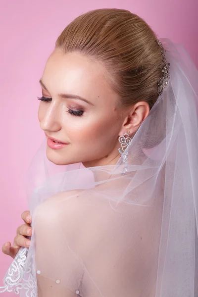 Beautiful young girl with a floral ornament in her hair.Beautiful Woman Touching her Face. Youth and Skin Care Concept