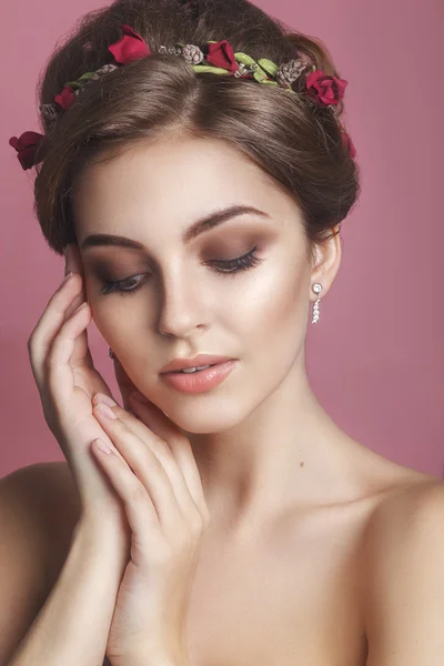 Beautiful young girl with a floral ornament in her hair.Beautiful Woman Touching her Face. Youth and Skin Care Concept