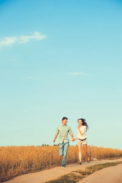 Young couple in love outdoor.Stunning sensual outdoor portrait of young stylish fashion couple posing in summer in field