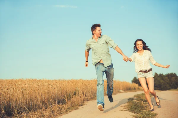 Young couple in love outdoor.Stunning sensual outdoor portrait of young stylish fashion couple posing in summer in field