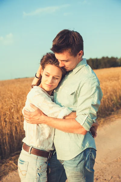 Young couple in love outdoor.Stunning sensual outdoor portrait of young stylish fashion couple posing in summer in field