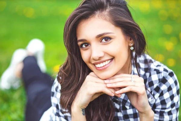 Summer girl portrait. Woman smiling happy on sunny summer or spring day outside in park