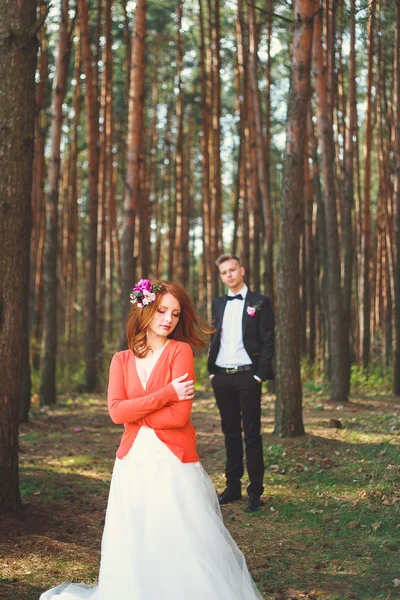 Wedding shot of bride and groom in park. Wedding couple just married with bridal bouquet. Stylish happy smiling newlyweds on outdoor wedding ceremony. Young couple in love outdoor.
