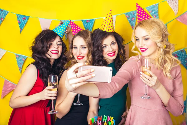 Best friends taking selfie .Portrait of joyful friends toasting and looking at camera at birthday party. Attractive friends celebrating a birthday. Smiling girls with glasses of champagne