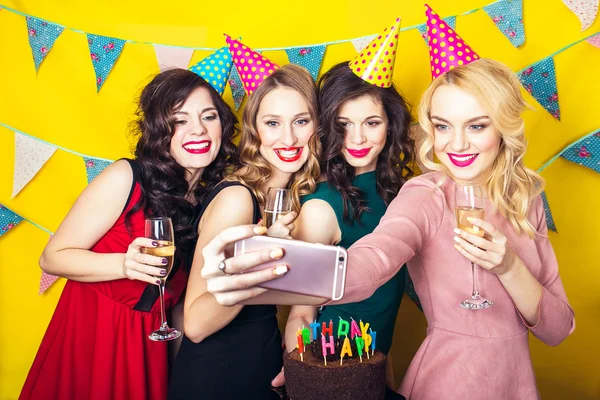 Best friends taking selfie .Portrait of joyful friends toasting and looking at camera at birthday party. Attractive friends celebrating a birthday. Smiling girls with glasses of champagne