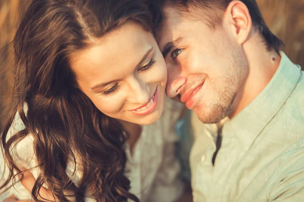 Young couple in love outdoor.Stunning sensual outdoor portrait of young stylish fashion couple posing in summer in  field