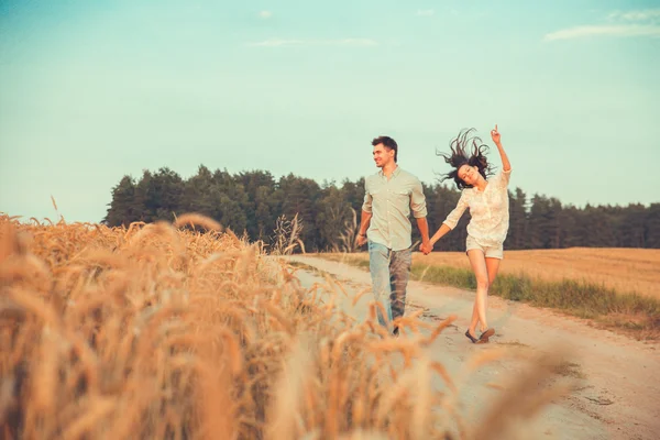 Young couple in love outdoor.Stunning sensual outdoor portrait of young stylish fashion couple posing in summer in  field