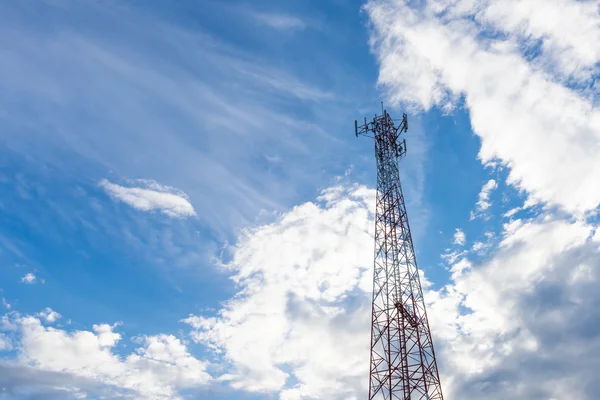 Mobile phone communication antenna tower with the blue sky and c