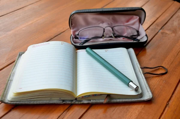 Pen on note book and Spectacles glasses