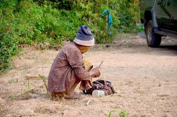 Old woman thai people use knife preparing betel vine for eat