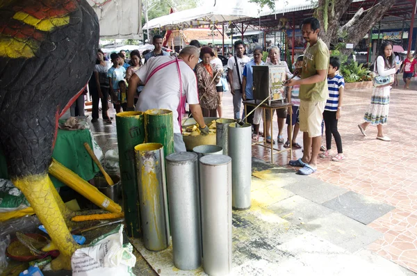 Thai people join melting cast candle offer to temple in traditio