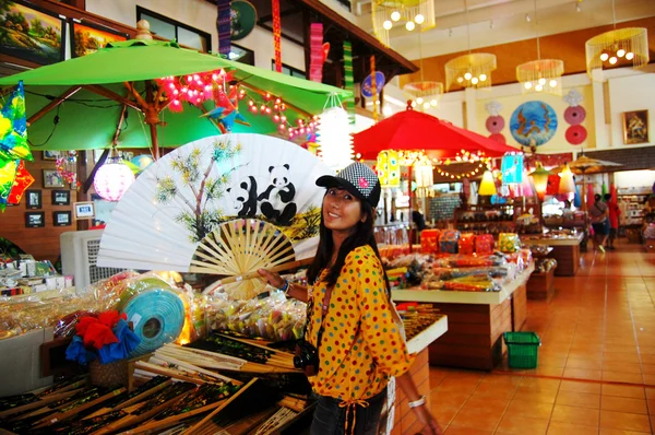 Thai women holding paper fan with Handmade Art Umbrella at Bo-sa