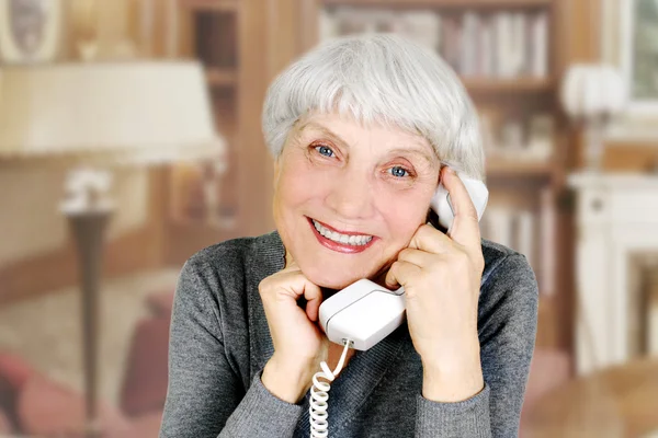 Elderly woman speaks on the phone, mother, grandmother