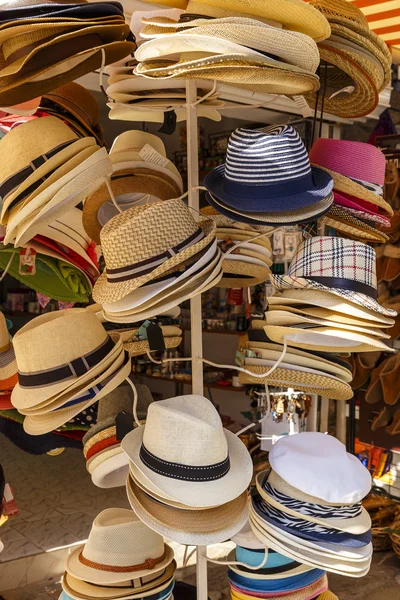 Summer hats hanging on a hanger in the store