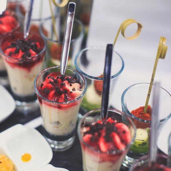 Beautifully decorated catering banquet table with different food snacks and appetizers with sandwich, caviar, fresh fruits on corporate christmas birthday party