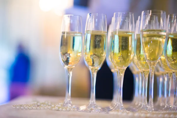 Beautiful line of different coloured cocktails with smoke on a open air party, tequila, martini, vodka, and others on decorated catering bouquet table on open air christmas party