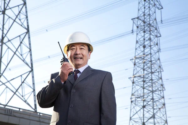 Construction manager on walkie talkie