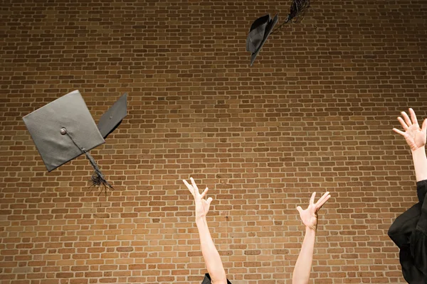 Graduates throwing their mortar boards