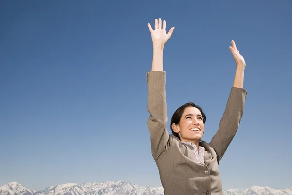 Businesswoman with arms raised