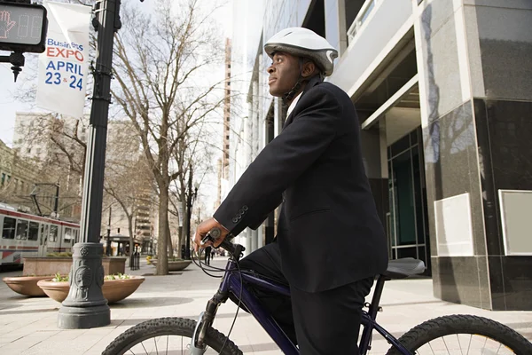 Businessman rides on bicycle