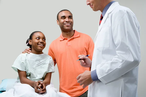 Father and daughter with doctor