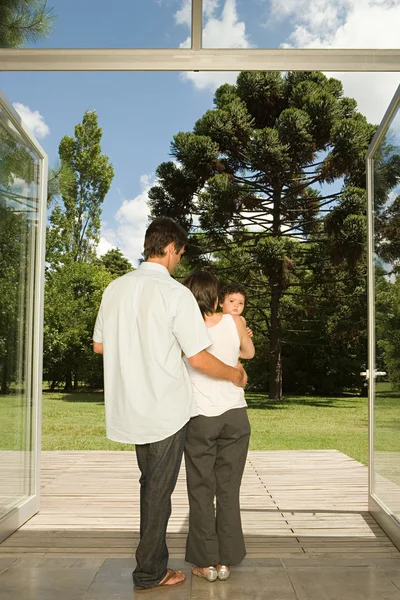 Family standing at doors to garden