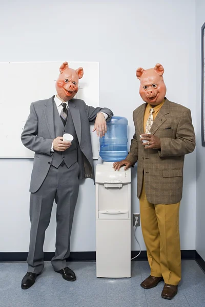 Two businessmen in pig masks