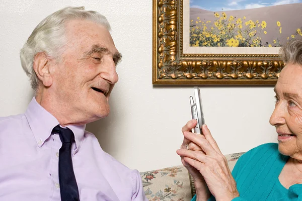 Senior couple using camera phone